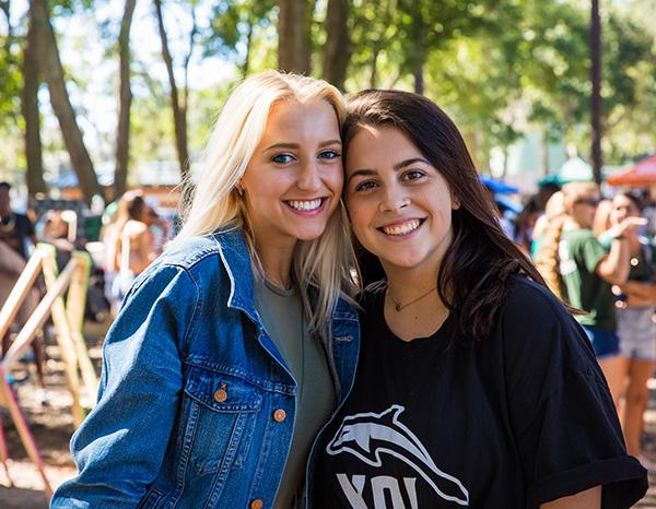 Two students in JU athletics gear smile for a picture.